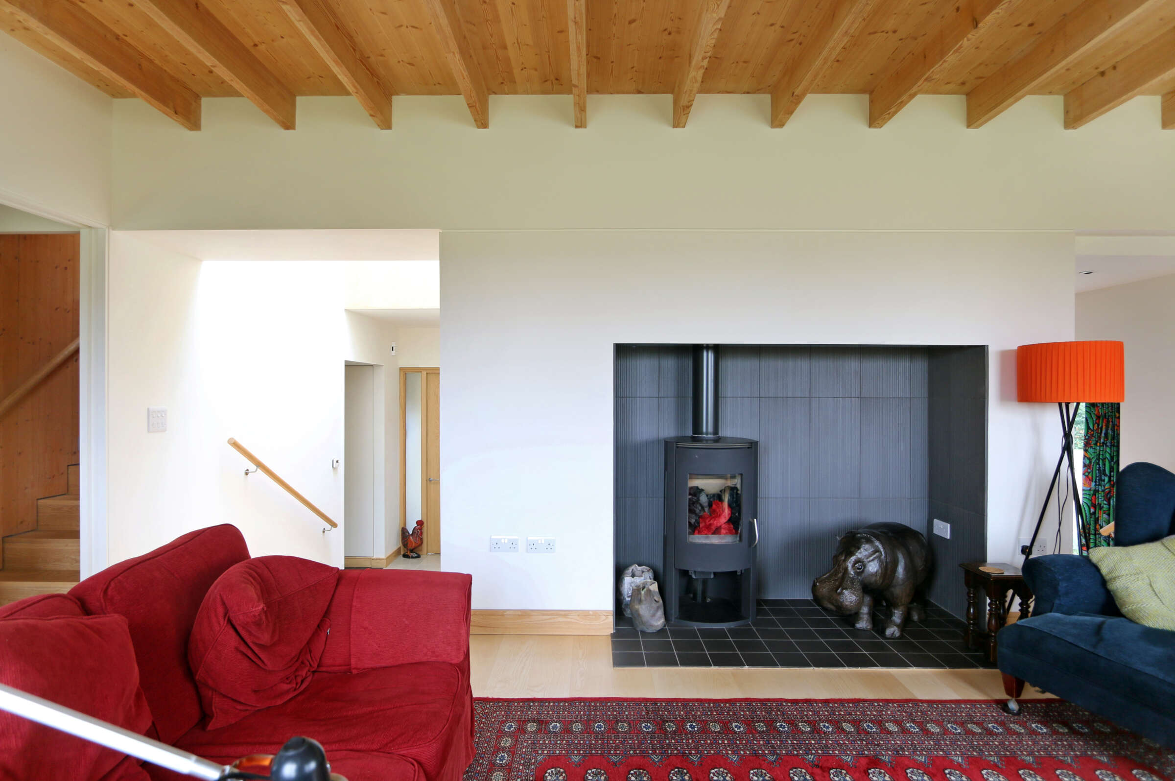 living space with recessed hearth and exposed timber ceiling. Palgrave award winning eco home. Threshold Architects Passivhaus Tim Offer South Devon South Hams