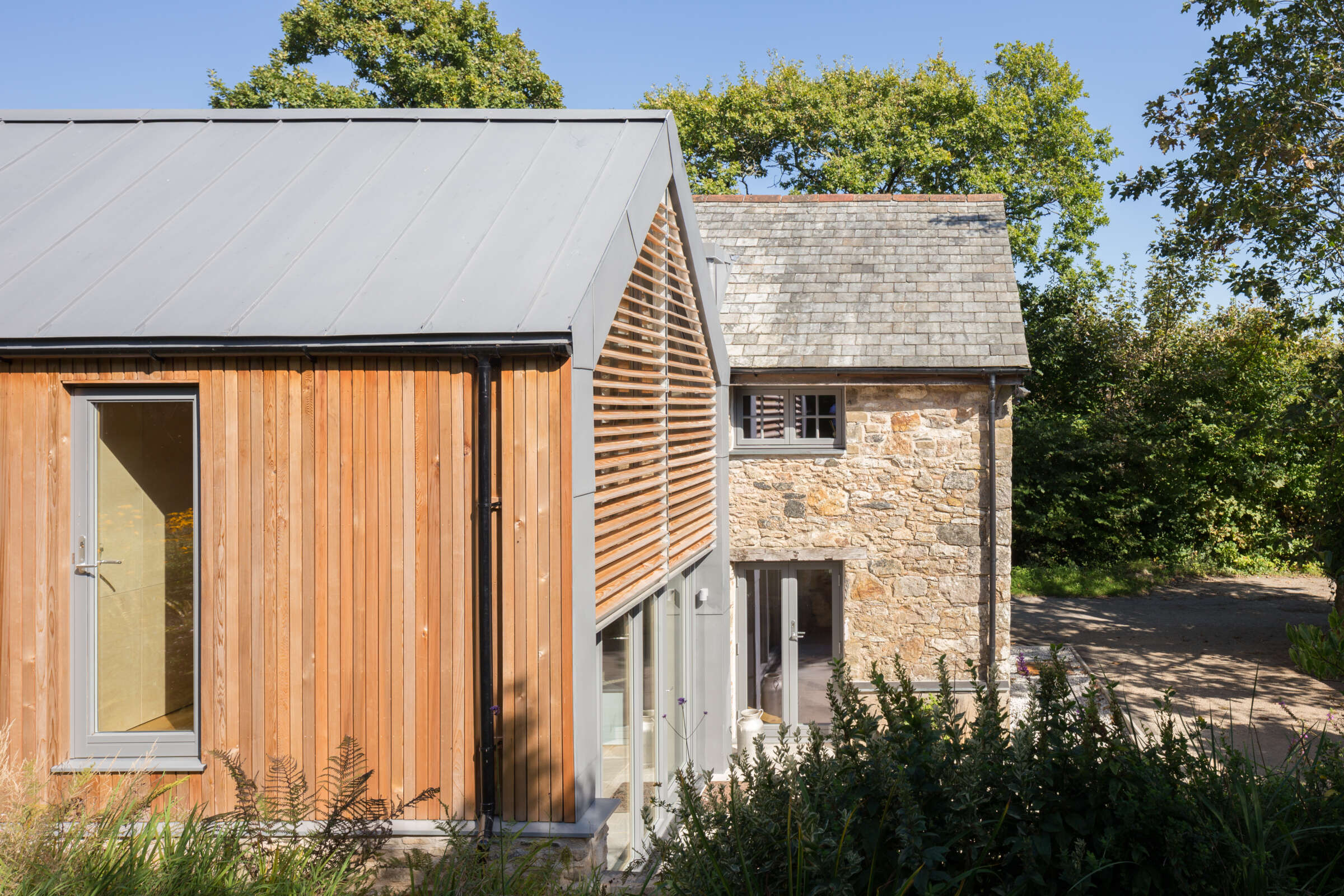 Repitition of original barn form in contemporary materials. Lutterburn award winning barn conversion. Threshold Architects Passivhaus Tim Offer South Devon South Hams