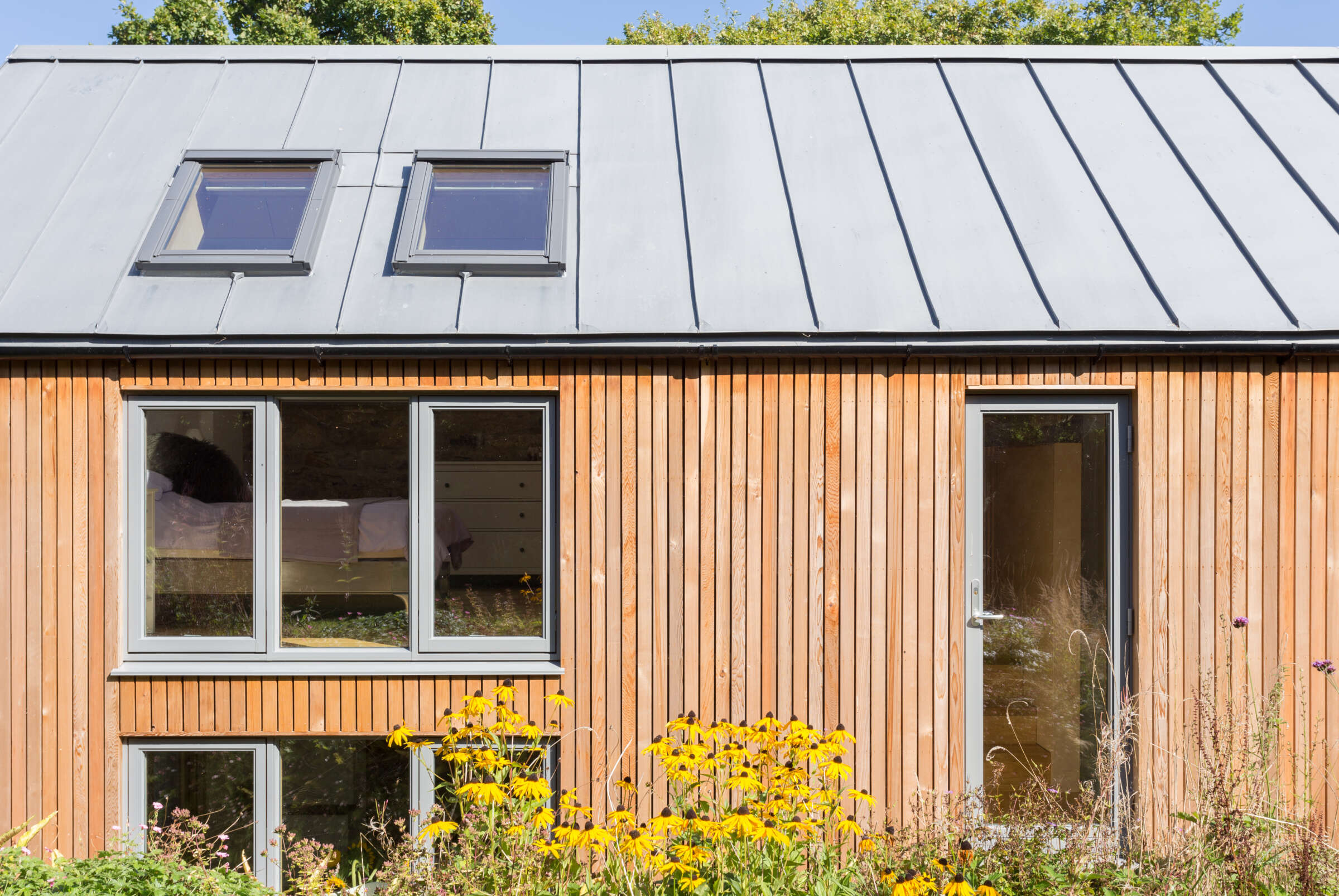 Zinc roof and cedar cladding. Lutterburn award winning barn conversion. Threshold Architects Passivhaus Tim Offer South Devon South Hams